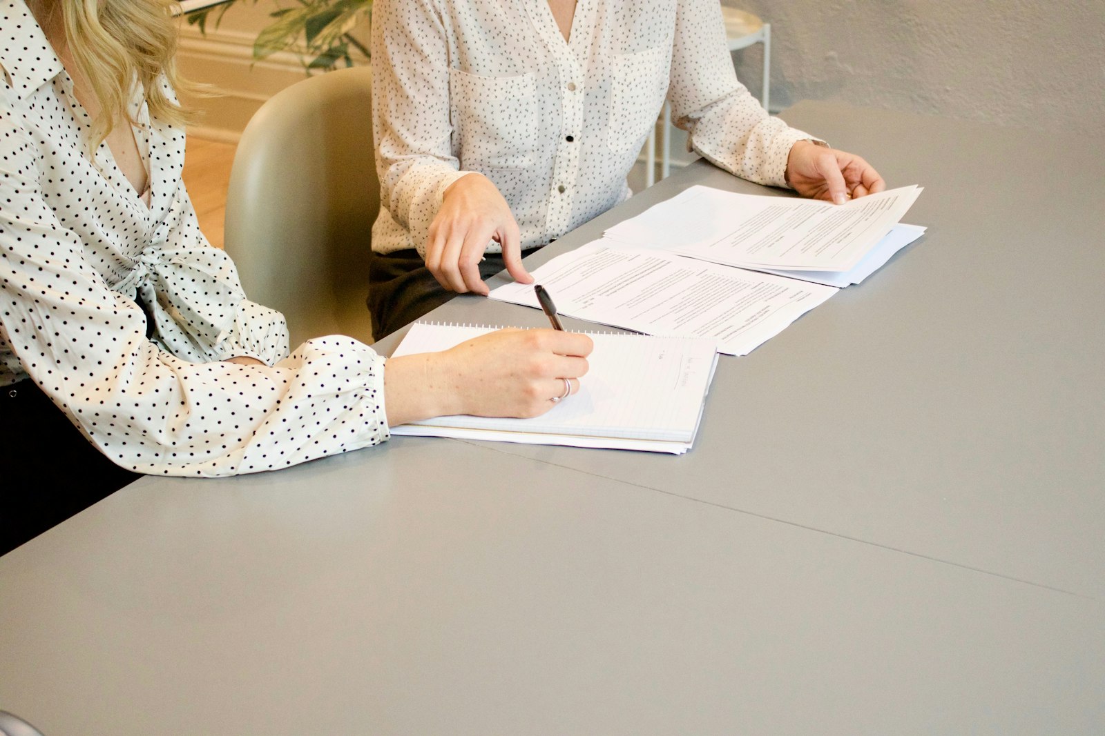 Two people reviewing and signing documents